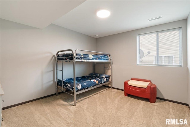 carpeted bedroom featuring visible vents and baseboards