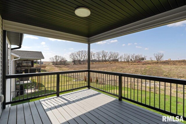 wooden deck featuring a yard