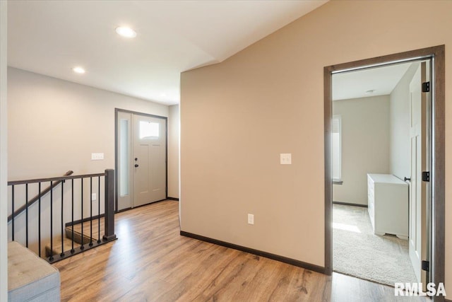 interior space featuring light wood-type flooring, baseboards, and recessed lighting