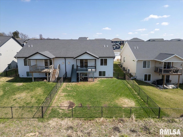 rear view of house with a yard, a fenced backyard, stairway, a wooden deck, and a residential view