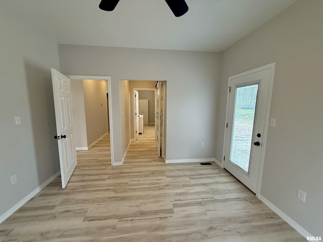 unfurnished bedroom featuring light wood-style flooring, access to outside, and baseboards