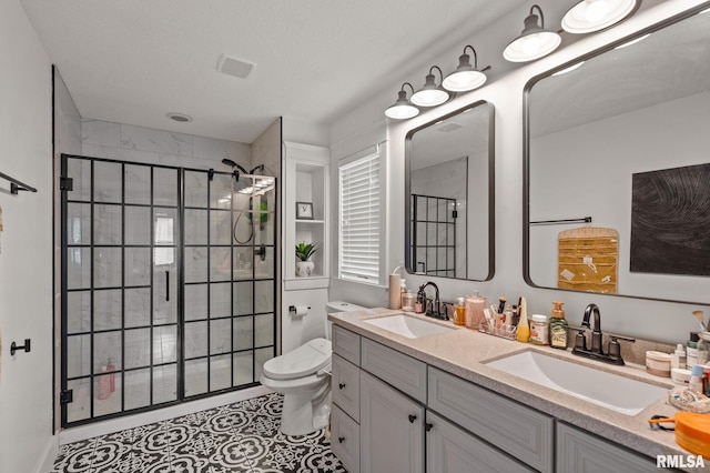 full bathroom with visible vents, a sink, and a stall shower