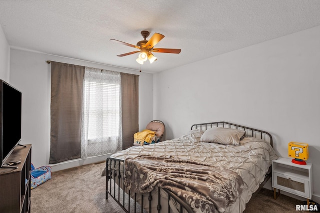 bedroom featuring ceiling fan, carpet flooring, and a textured ceiling