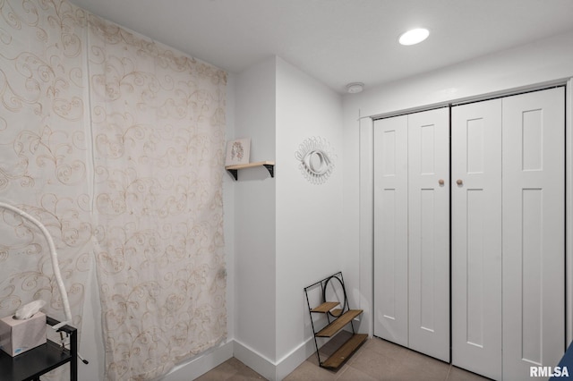 interior space featuring tile patterned floors, baseboards, and recessed lighting