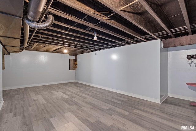 finished below grade area featuring baseboards and wood finished floors
