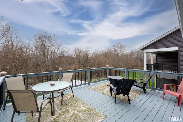 wooden terrace with outdoor dining space