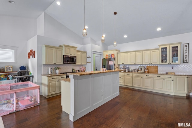 kitchen with backsplash, cream cabinets, light stone counters, and stainless steel appliances