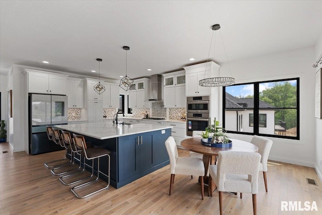 6817 Timber Ct, Bettendorf, IA 52722 - kitchen featuring wall chimney range hood, smart refrigerator, a sink, stainless steel double oven, and backsplash