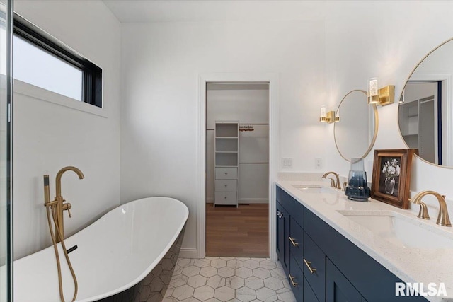 6817 Timber Ct, Bettendorf, IA 52722 - full bath featuring tile patterned floors, double vanity, and a freestanding tub