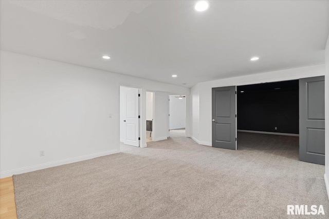 6817 Timber Ct, Bettendorf, IA 52722 - unfurnished bedroom with recessed lighting, baseboards, and light carpet