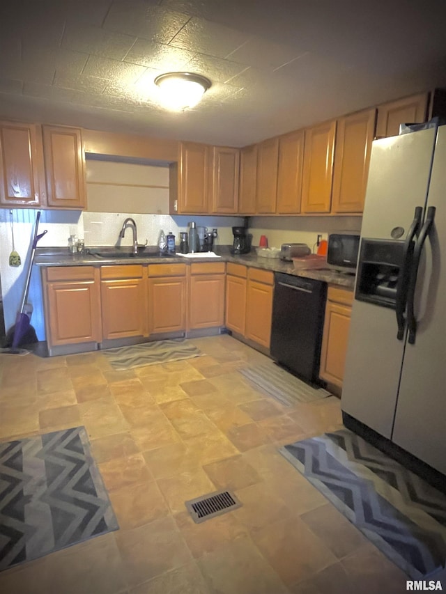 225 Arrowhead Dr, Goreville, IL 62939 - kitchen with stainless steel microwave, white fridge with ice dispenser, black dishwasher, visible vents, and a sink