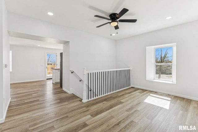 spare room with recessed lighting, ceiling fan, baseboards, and wood finished floors