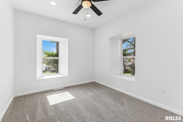 carpeted empty room with recessed lighting, visible vents, baseboards, and a ceiling fan