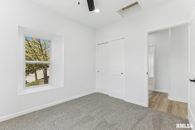 unfurnished bedroom with a closet, baseboards, a ceiling fan, and carpet