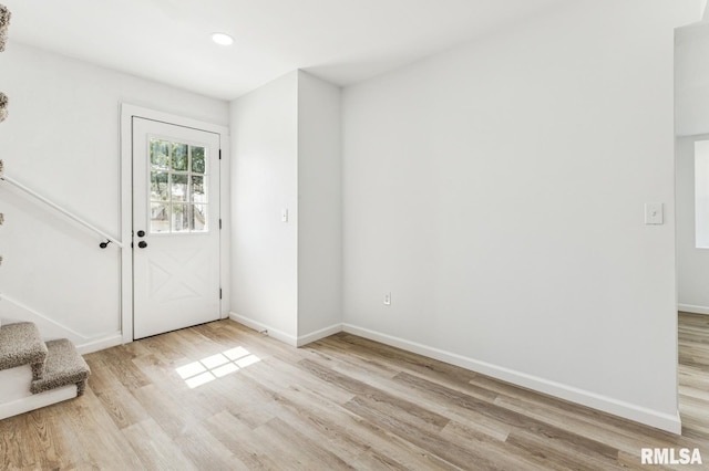 foyer entrance with baseboards, recessed lighting, light wood-style floors, and stairs