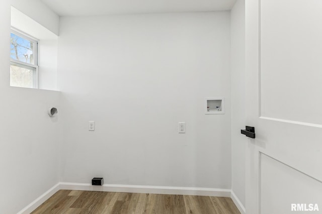 clothes washing area featuring laundry area, wood finished floors, washer hookup, and baseboards