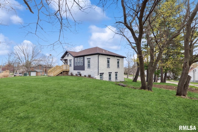 view of home's exterior featuring a lawn and roof with shingles