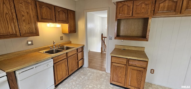 1606 Middle Rd, Camanche, IA 52730 - kitchen with dishwasher, a sink, light countertops, and brown cabinets