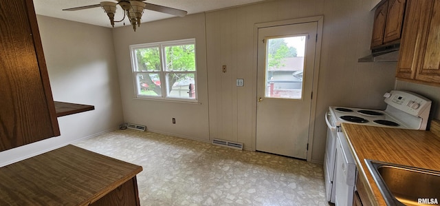 1606 Middle Rd, Camanche, IA 52730 - kitchen with white range with electric cooktop, under cabinet range hood, a sink, ceiling fan, and light flooring