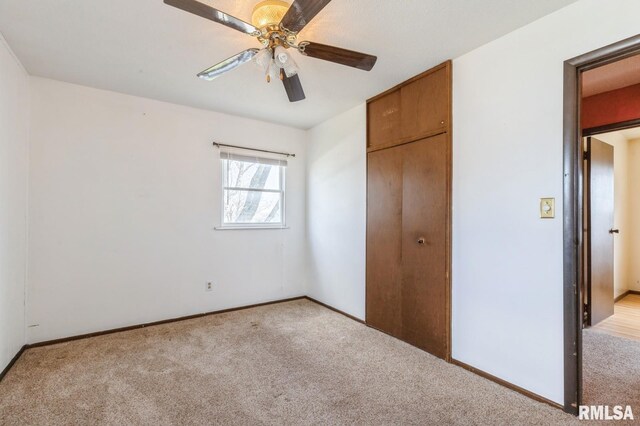 1606 Middle Rd, Camanche, IA 52730 - unfurnished bedroom featuring carpet flooring, a closet, ceiling fan, and baseboards