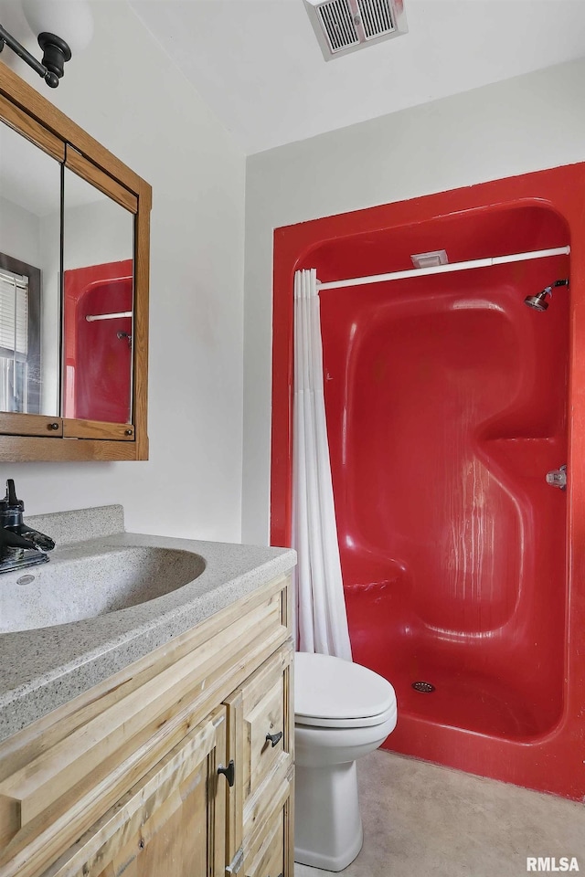 full bathroom with visible vents, toilet, a shower stall, and vanity