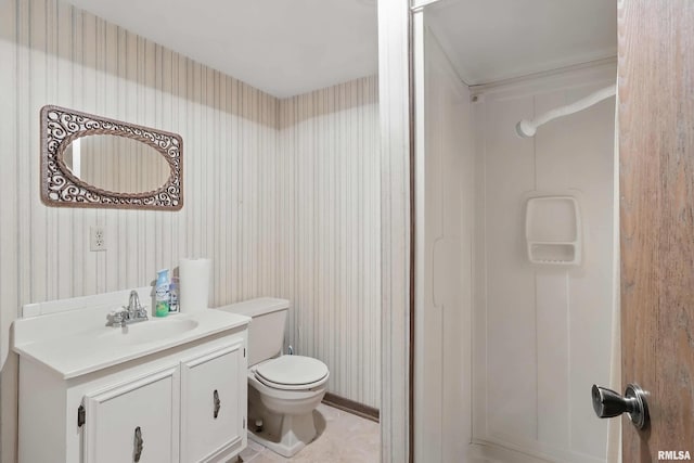 bathroom with tile patterned floors, vanity, wallpapered walls, and toilet
