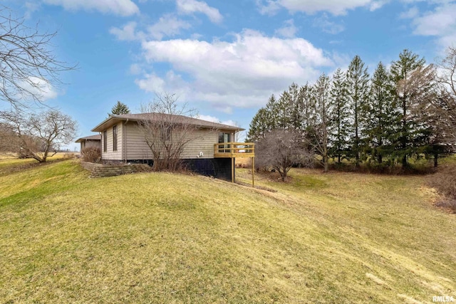 exterior space with a deck and a lawn