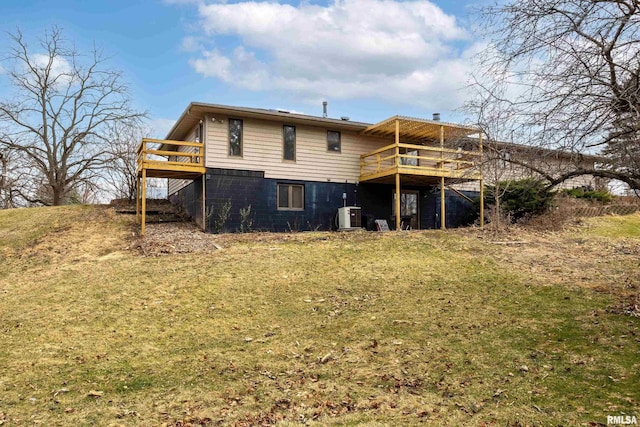 back of property featuring a deck, a lawn, and central air condition unit