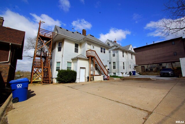 705 Brady St, Davenport, IA 52803 - rear view of house with a chimney and stairs