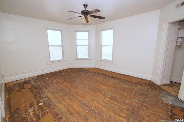 705 Brady St, Davenport, IA 52803 - unfurnished room with hardwood / wood-style floors, baseboards, ceiling fan, and visible vents