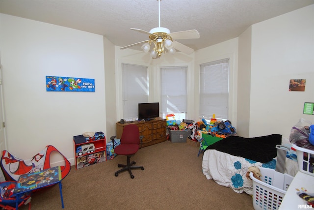 705 Brady St, Davenport, IA 52803 - carpeted bedroom with a textured ceiling and a ceiling fan