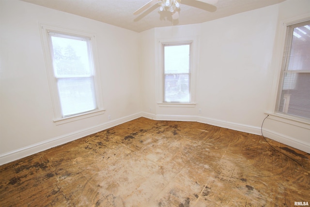 705 Brady St, Davenport, IA 52803 - empty room with baseboards, a ceiling fan, and a wealth of natural light