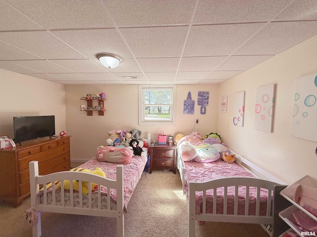 bedroom featuring a paneled ceiling and carpet flooring