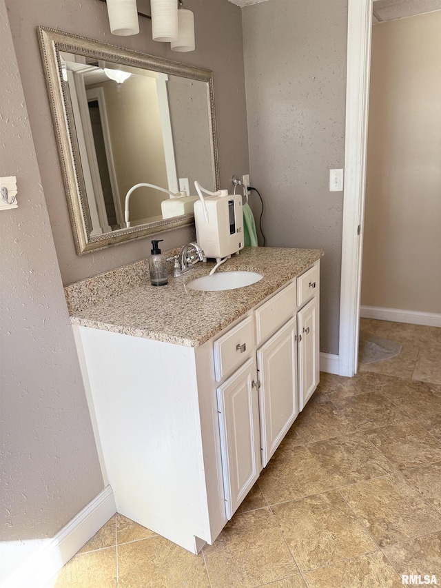 bathroom featuring baseboards and vanity