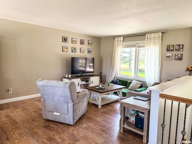 living area featuring baseboards and wood finished floors