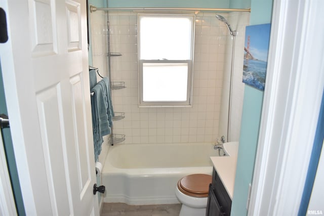 bathroom featuring toilet, vanity, and  shower combination
