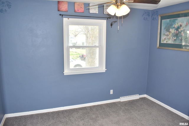 carpeted spare room with visible vents, baseboards, and ceiling fan