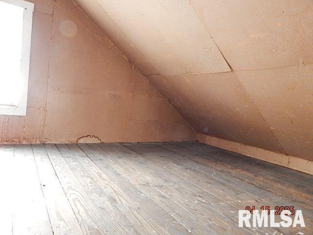 bonus room with hardwood / wood-style floors and lofted ceiling