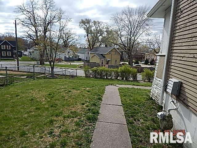 view of yard with fence and a residential view