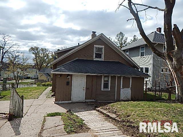 bungalow-style house with fence, a front lawn, roof with shingles, and a chimney
