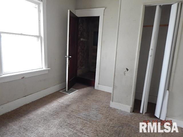 unfurnished bedroom featuring visible vents and carpet flooring