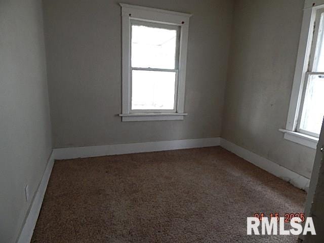 carpeted empty room with baseboards