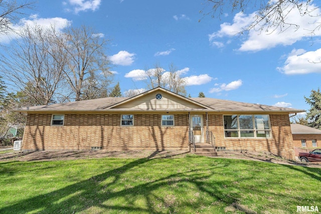 ranch-style home with brick siding and a front yard