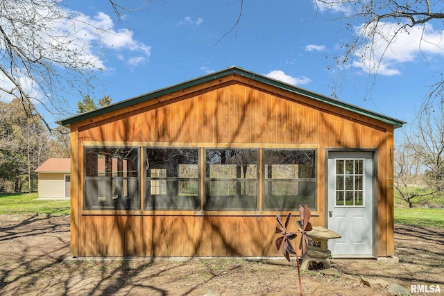 back of house with an outbuilding