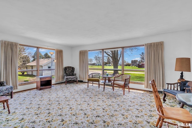 sitting room with plenty of natural light and baseboards