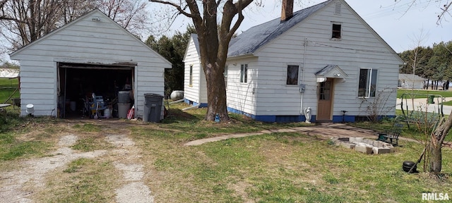 18304 W 206th St, Buffalo Prairie, IL 61237 - back of property featuring a chimney, driveway, an outbuilding, and a garage