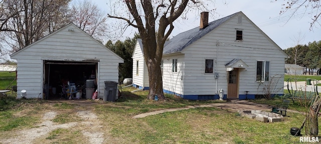 18304 W 206th St, Buffalo Prairie, IL 61237 - exterior space with dirt driveway, an outdoor structure, a chimney, and a detached garage