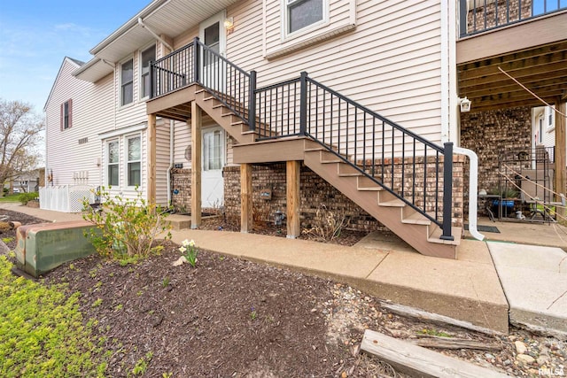 view of exterior entry featuring a balcony