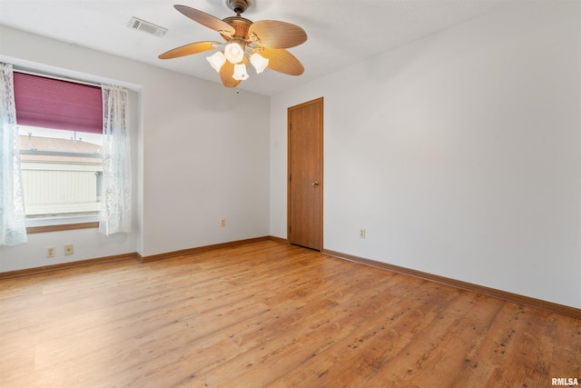unfurnished room with baseboards, visible vents, and light wood-style floors