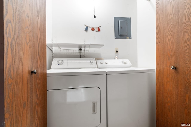 laundry room with washing machine and clothes dryer, electric panel, and laundry area